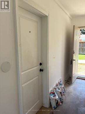 St. Catharines (Carlton/Bunting) apartment for rent - A white door with a black handle and a round white plate on the wall.