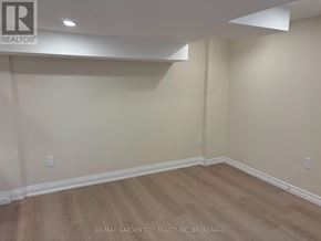 St. Catharines (Carlton/Bunting) apartment for rent - A room with wooden flooring and white walls.