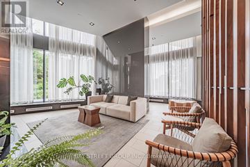 Toronto (Thorncliffe Park) condo for rent - A living room with a white couch and a wooden coffee table.