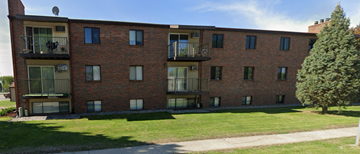 Dilworth apartment for rent - A red brick building with a green lawn in front.