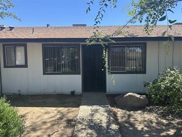 Chowchilla apartment for rent - A small white house with a black door and windows.