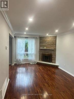 Toronto (Agincourt North) apartment for rent - A room with a fireplace and wooden floors.