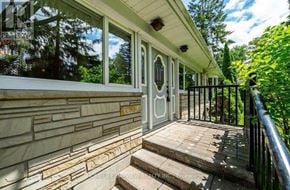 Whitchurch-Stouffville apartment for rent - A house with a white door and a staircase leading to the front door.