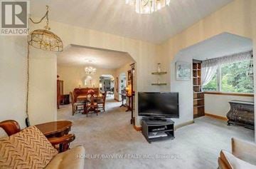 Whitchurch-Stouffville apartment for rent - A living room with a television and a fireplace.