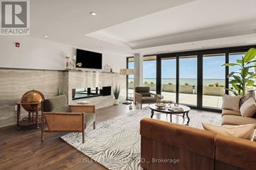 Fort Erie (Crystal Beach) condo for rent - A living room with a brown couch and a large window overlooking the beach.