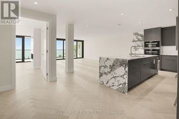 Fort Erie (Crystal Beach) condo for rent - A spacious kitchen with a marble island and modern appliances.