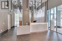 Toronto (Church-Yonge Corridor) condo for rent - A realtor's office with a white reception desk and a glass door.