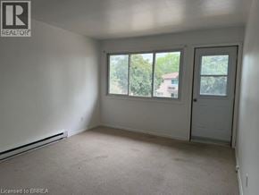 Brantford apartment for rent - A room with a door, windows and a carpeted floor.