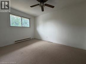 Brantford apartment for rent - A room with a ceiling fan and a window.