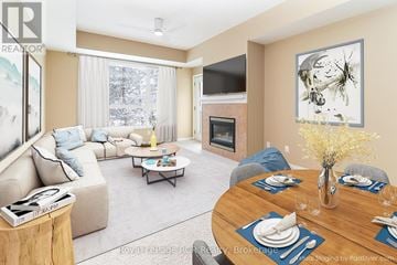 Collingwood condo for rent - A living room with a fireplace and a dining table set for six.
