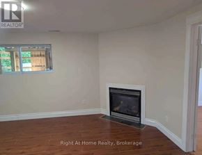 Clarington (Bowmanville) apartment for rent - A room with a fireplace and a window.
