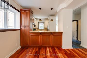Ottawa apartment for rent - A kitchen with wooden cabinets and a red and white striped floor.
