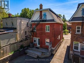 Ottawa apartment for rent - A red brick house with a balcony is for sale.