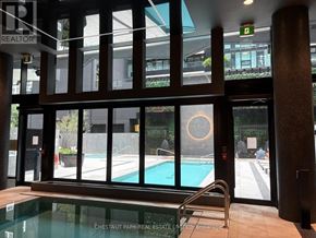 Toronto (Mount Pleasant West) condo for rent - A pool area with a glass wall and a pool table.