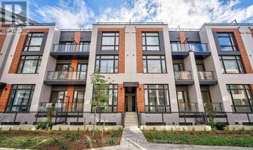 Richmond Hill townhouse for rent - A modern apartment building with balconies and a clear sky in the background.
