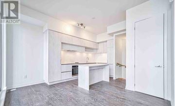 Richmond Hill townhouse for rent - A modern kitchen with white cabinets and a central island.