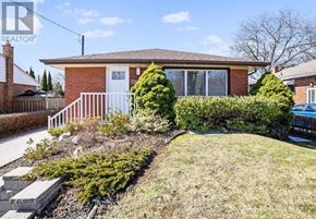 Burlington (Mountainside) apartment for rent - A house with a white fence and a green lawn.