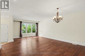 Ottawa apartment for rent - A room with wooden floors and a chandelier.