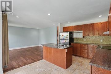 Ottawa apartment for rent - A kitchen with wooden cabinets and a refrigerator.
