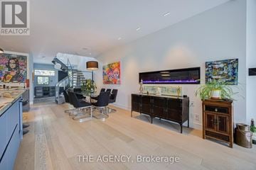 Toronto (North Riverdale) apartment for rent - A living room with a wooden floor and a large painting on the wall.
