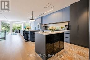 Toronto (North Riverdale) apartment for rent - A modern kitchen with dark grey cabinets and a central island.