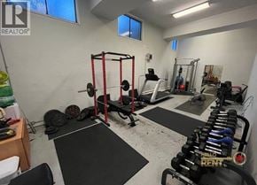 Burnaby apartment for rent - A gym with a variety of equipment including weights and a squat rack.