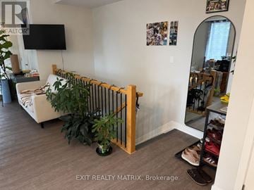 Russell condo for rent - A living room with a white couch and a TV mounted on the wall.
