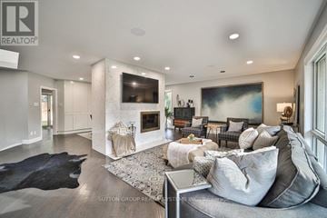 Toronto (Princess-Rosethorn) apartment for rent - A modern living room with a black cowhide rug and a grey sofa.