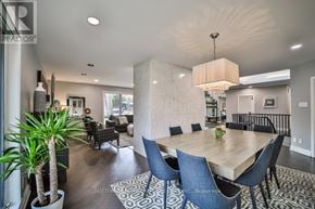 Toronto (Princess-Rosethorn) apartment for rent - A dining room with a wooden table surrounded by chairs.