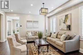 Oakville (Jm Joshua Meadows) apartment for rent - A living room with a sofa, two chairs, and a coffee table.