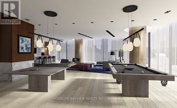 Toronto (North St. James Town) condo for rent - A modern living room with a pool table and a view of the city.