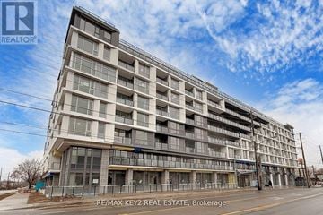 Toronto (Yorkdale-Glen Park) condo for rent - A large, multi-story building under construction with the RE/MAX Key2 Real Estate Brokerage logo on the top left.