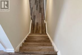 Hamilton (Lawfield) apartment for rent - A staircase with wooden steps and white walls.