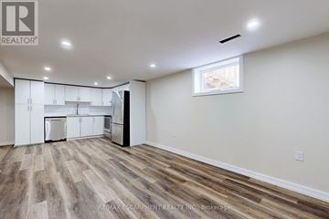 Hamilton (Lawfield) apartment for rent - A kitchen with white cabinets and a window.