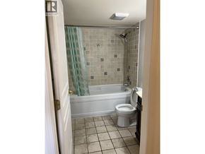 Vancouver apartment for rent - A bathroom with a toilet, tub, and shower.