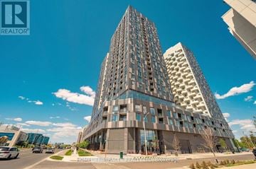 Vaughan (Concord) condo for rent - A tall building with a unique design is the focal point of the image.