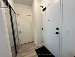Vaughan (Concord) condo for rent - A hallway with a white door and a black mat on the floor.