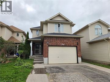 Kitchener apartment for rent - A house with a garage and a driveway in front.