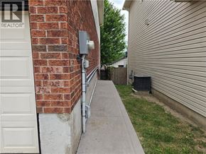 Kitchener apartment for rent - A white door is on the left of a brick wall.