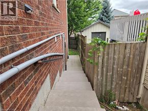 Kitchener apartment for rent - A red lantern is hanging on a fence in a backyard.