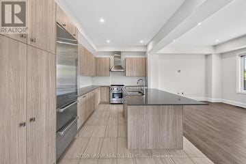 Vaughan (Kleinburg) apartment for rent - A modern kitchen with wooden cabinets and stainless steel appliances.