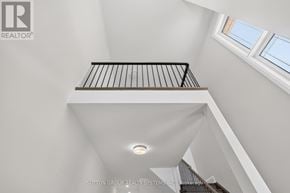 Vaughan (Kleinburg) apartment for rent - A staircase with a metal railing and a light on the ceiling.
