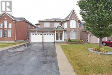 Brampton (Vales Of Castlemore) apartment for rent - A large brick house with a driveway in front.