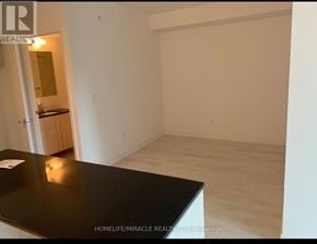 Toronto (Clanton Park) condo for rent - A room with a black countertop and wooden flooring.