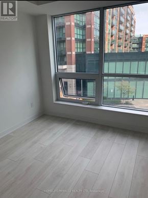 Toronto (Clanton Park) condo for rent - A room with a large window overlooking a cityscape.