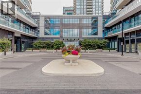 Mississauga condo for rent - A courtyard with a fountain and a flower arrangement in the middle.