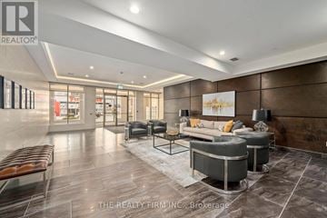 London East (East K) condo for rent - A modern living room with a grey sofa set and a coffee table.