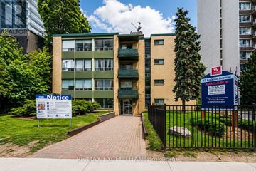 Toronto (Mount Pleasant West) condo for rent - A building with a notice board in front of it.
