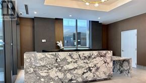 Toronto (Waterfront Communities) condo for rent - A reception area with a marble counter and a flower vase.