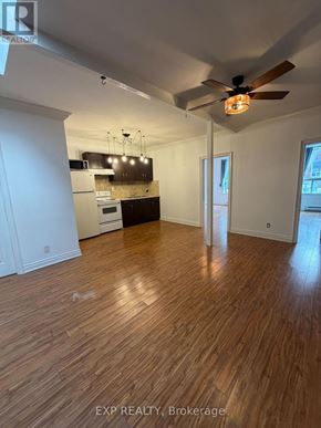 Toronto (Junction Area) multi-family for rent - A room with wooden flooring and a ceiling fan.